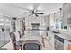 Open-concept kitchen featuring white cabinetry, granite countertops, stainless steel appliances, and a functional island with seating at 4250 Edgewater Nw Ct, Kennesaw, GA 30144