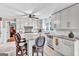Renovated kitchen with white cabinets, granite counters, stainless appliances, and a functional island with seating and a view to another room at 4250 Edgewater Nw Ct, Kennesaw, GA 30144
