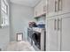 Well-lit laundry room with modern washer and dryer, ample storage cabinets, and a window at 4250 Edgewater Nw Ct, Kennesaw, GA 30144