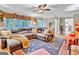 Spacious living room with a large sectional sofa, neutral walls, and access to an outdoor area and a view to other rooms at 4250 Edgewater Nw Ct, Kennesaw, GA 30144