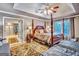 Luxurious main bedroom features a four-poster bed, tray ceiling, and ensuite bathroom access at 4250 Edgewater Nw Ct, Kennesaw, GA 30144