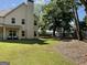 Large backyard featuring a two-story home, spacious lawn, and shaded areas with mature trees at 101 Elkins Blvd, Locust Grove, GA 30248