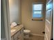 Bathroom featuring granite countertop, white cabinets, and a large window at 101 Elkins Blvd, Locust Grove, GA 30248