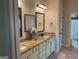 Bathroom featuring double vanity with granite countertop, white cabinets, and modern lighting at 101 Elkins Blvd, Locust Grove, GA 30248
