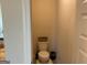 Cozy powder room with a toilet and wall decor at 101 Elkins Blvd, Locust Grove, GA 30248