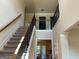 Open foyer with staircase, wrought iron railings, and view to second story at 101 Elkins Blvd, Locust Grove, GA 30248
