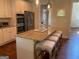 Charming kitchen island with seating, stainless steel appliances, double oven, and view to a doorway at 101 Elkins Blvd, Locust Grove, GA 30248