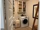Well-organized laundry room featuring a washer, dryer, and plenty of storage space at 101 Elkins Blvd, Locust Grove, GA 30248