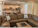 Open-concept living room featuring leather sofa and view of kitchen and dining area at 101 Elkins Blvd, Locust Grove, GA 30248