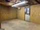 Unfinished basement space featuring partial plywood walls and electrical panels at 115 Stable Creek Rd, Fayetteville, GA 30215