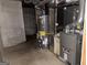 Basement mechanical area with water heater and furnace, showcasing efficient utility systems at 115 Stable Creek Rd, Fayetteville, GA 30215