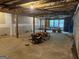 Large, unfinished basement with concrete floor, framing and some windows, offering renovation potential at 115 Stable Creek Rd, Fayetteville, GA 30215