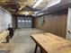 Unfinished basement space with exposed ceiling and garage door, ready for customization at 115 Stable Creek Rd, Fayetteville, GA 30215
