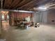 Unfinished basement with exposed ceiling and brick accent wall, ready for customization and ample storage at 115 Stable Creek Rd, Fayetteville, GA 30215
