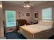 Bedroom featuring a ceiling fan and windows for natural light at 115 Stable Creek Rd, Fayetteville, GA 30215