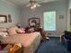 Bedroom featuring a ceiling fan, area rug, and window for natural light at 115 Stable Creek Rd, Fayetteville, GA 30215