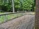 Spacious wooden deck surrounded by lush trees, offering a private outdoor space to enjoy the peaceful backyard at 115 Stable Creek Rd, Fayetteville, GA 30215