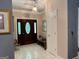 Inviting foyer with decorative glass front door, chandelier, and neutral tile flooring at 115 Stable Creek Rd, Fayetteville, GA 30215