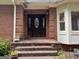Charming brick entrance with a classic wood door and decorative glass accents, adding curb appeal to the home at 115 Stable Creek Rd, Fayetteville, GA 30215