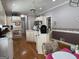Spacious kitchen with white cabinetry, an island, hardwood floors and stainless steel appliances at 115 Stable Creek Rd, Fayetteville, GA 30215