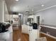 Spacious kitchen with white cabinetry, an island, hardwood floors and stainless steel appliances at 115 Stable Creek Rd, Fayetteville, GA 30215