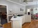 Open kitchen featuring an island, white cabinets, hardwood floors, and recessed lighting at 115 Stable Creek Rd, Fayetteville, GA 30215