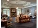 Spacious living room featuring a fireplace, coffered ceilings and recessed lighting at 115 Stable Creek Rd, Fayetteville, GA 30215