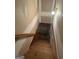 Wooden staircase leading to the basement, featuring natural wood and a neutral color palette, ready for finishing at 115 Stable Creek Rd, Fayetteville, GA 30215