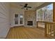Covered back deck features a stone fireplace and wooded view at 135 Wet Wood Dr # 12, Fairburn, GA 30213