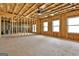 Unfinished basement offering a blank canvas with exposed framing and natural light from multiple windows at 135 Wet Wood Dr # 12, Fairburn, GA 30213