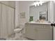 Stylish bathroom featuring gray vanity with gold fixtures, star pattern tile, and shower with curtain at 135 Wet Wood Dr # 12, Fairburn, GA 30213