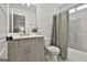Modern bathroom with a vanity with gold hardware and a shower/tub combination with a gray shower curtain at 135 Wet Wood Dr # 12, Fairburn, GA 30213