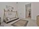 Bright bedroom with a modern teepee style bed, patterned rug, and access to closet and hallway at 135 Wet Wood Dr # 12, Fairburn, GA 30213