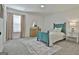 Bright bedroom features a blue bed, dresser, and area rug at 135 Wet Wood Dr # 12, Fairburn, GA 30213