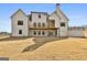 View of the back of a two-story home featuring a spacious wooden deck and ample backyard at 135 Wet Wood Dr # 12, Fairburn, GA 30213