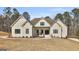 Stunning new construction home with white painted brick, black trim, and a beautifully landscaped front yard at 135 Wet Wood Dr # 12, Fairburn, GA 30213