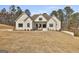 Charming single-Gathering home featuring painted brick, a manicured lawn, and a walkway to the front entrance at 135 Wet Wood Dr # 12, Fairburn, GA 30213