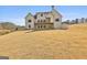 Backyard view of a new construction home with a large yard and deck perfect for entertaining at 135 Wet Wood Dr # 12, Fairburn, GA 30213