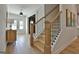 Bright foyer featuring light hardwood floors, staircase with wooden posts and black railings at 135 Wet Wood Dr # 12, Fairburn, GA 30213