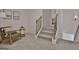 Cozy hallway with carpeted stairs, a comfortable chair, and decorative wall art at 135 Wet Wood Dr # 12, Fairburn, GA 30213