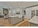 Open concept kitchen featuring a center island, farmhouse sink, and stainless steel appliances at 135 Wet Wood Dr # 12, Fairburn, GA 30213