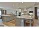 Spacious kitchen features gray cabinets, stainless appliances, and a large island with quartz countertops at 135 Wet Wood Dr # 12, Fairburn, GA 30213