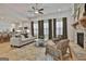 Open-concept living room featuring a stone fireplace and ample natural light at 135 Wet Wood Dr # 12, Fairburn, GA 30213