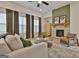 Comfortable living room with fireplace, curtains and great natural light at 135 Wet Wood Dr # 12, Fairburn, GA 30213