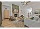 Well-lit living room with fireplace, seating, and seamless transition to the stairway at 135 Wet Wood Dr # 12, Fairburn, GA 30213