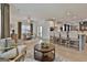 Open-concept kitchen and living room with stainless steel appliances and breakfast bar at 135 Wet Wood Dr # 12, Fairburn, GA 30213
