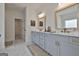 Bright bathroom with double vanity, marble countertops, designer mirrors, and stylish fixtures at 135 Wet Wood Dr # 12, Fairburn, GA 30213