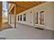 Covered patio with access to the home, featuring wood beams and views of the lush surrounding landscape at 135 Wet Wood Dr # 12, Fairburn, GA 30213