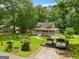 Aerial view of a charming home with a covered porch, well-maintained lawn, and mature trees at 3777 Edward Rd, Rex, GA 30273