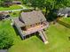Aerial view showcasing the house with a spacious deck, lush green yard and well-maintained landscaping at 3777 Edward Rd, Rex, GA 30273